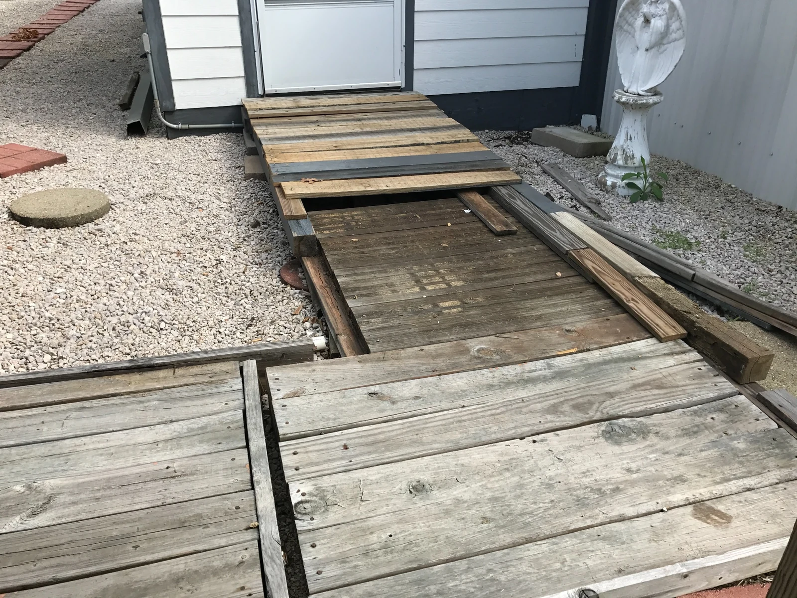 Deteriorated wooden walkway before repair