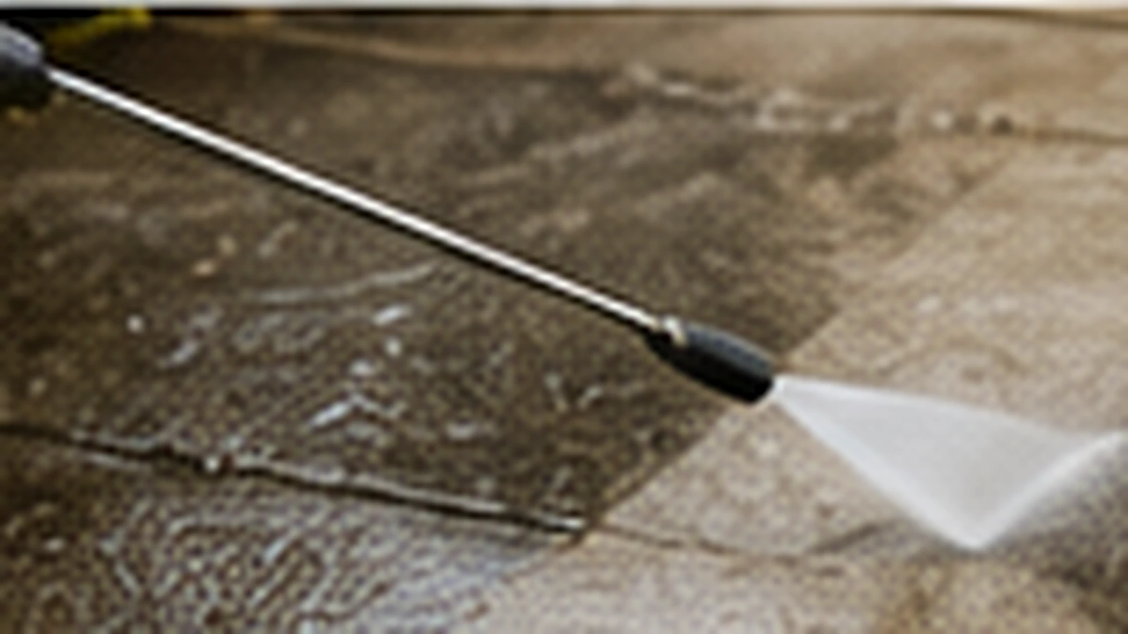Pressure washing a paved exterior surface